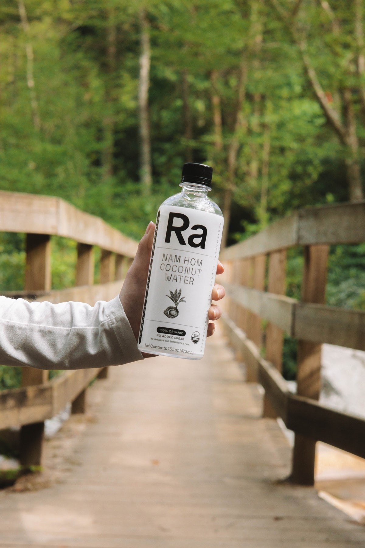 Ra coconut water held outdoors